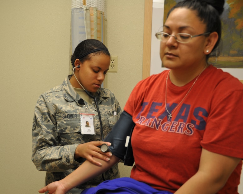 GOODFELLOW AIR FORCE BASE, Texas- Airman 1st Class Brionna Glover, 17th Medical Operations Squadron, takes the blood pressure of a patient at the 17th Medical Group Clinic here, April 30. Glover not only oversees health care of San Angelo community members but also takes time off duty to volunteer within the community. (U.S. Air Force photo/ Airman 1st Class Erica Rodriguez)