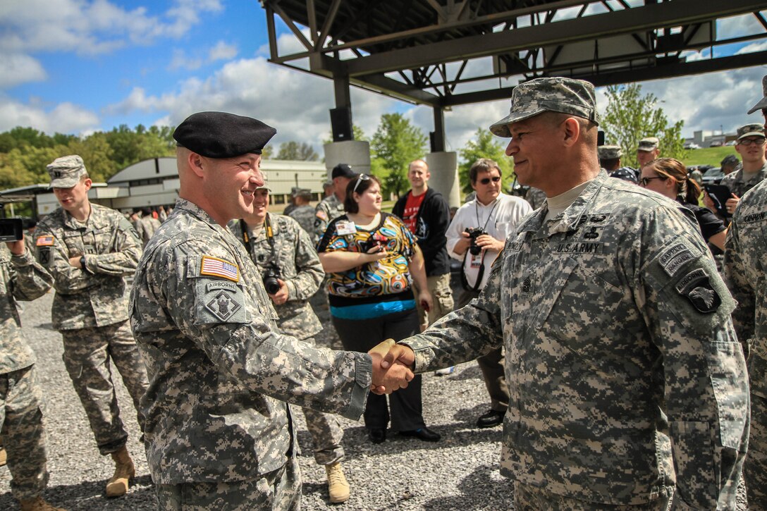 Army Sgt. 1st Class Greg Robinson, left, receives a handshake from Army Command Sgt. Maj. Harold Reynolds after Robinson’s Sabalauski Air Assault School graduation at Fort Campbell, Ky., April 29, 2013. Robinson is the first amputee to graduate from the school. U.S. Army photo by Sgt. Joe Padula