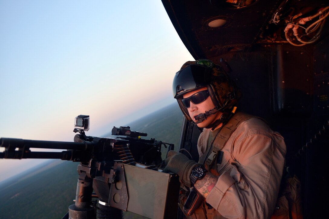 A Marine Corps UH-1N Huey crew chief assigned to the 773rd Marine Light Attack Helicopter Squadron prepares to provide close air support with the M240B machine gun during a flight in support of Emerald Warrior 2013 on Hurlburt Field, Fla., April 25, 2013.