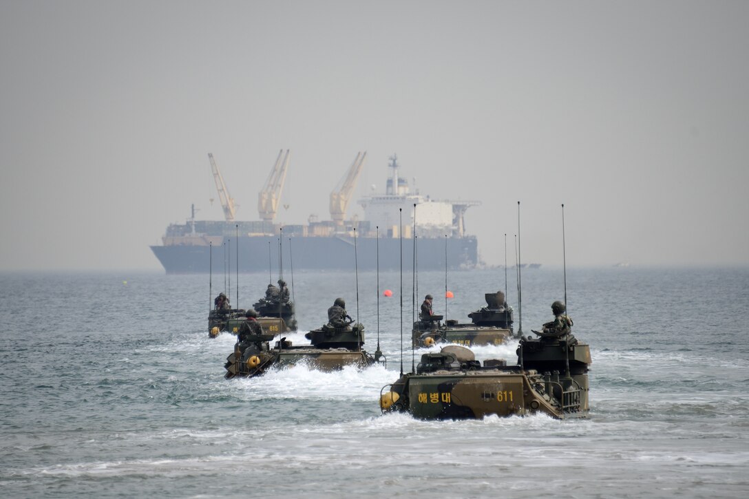 Republic of Korea Marine Corps assault amphibious vehicle operators conduct formation maneuvers April 16 near Dogu Beach, Pohang, Republic of Korea, as the USNS 2nd Lt. John P. Bobo is prepared for off-load. The Bobo, a container and roll-on/roll-off ship, is part of the U.S. Navy’s Military Sealift Command’s maritime prepositioning force program. The ship is participating in Combined Joint Logistics Over The Shore 2013, a biennial MPF exercise. The ROK Marine Corps and Navy are scheduled to work with III Marine Expeditionary Force, Army forces with U.S. Forces Korea, Navy Expeditionary Strike Group 3 and Coast Guard Port Security Unit 313 during the exercise. The ROK AAV crews are with 1st Assault Amphibian Battalion, 1st Marine Division, ROK Marine Corps. Photo by Cpl. Mark W. Stroud