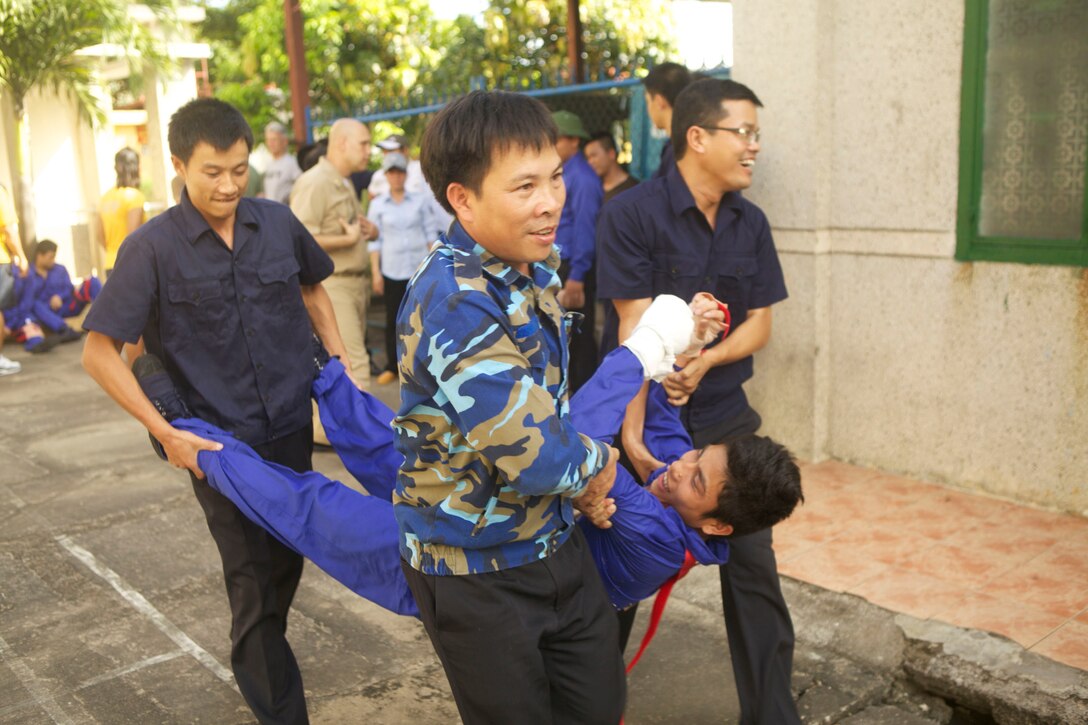 Members of the Vietnam People’s Navy move a simulated patient to be transported to the next level of care during a simulated mass casualty event April 23 as a part of Naval Exchange Activity 2013 in Da Nang, Vietnam. (U.S. Marine Corps photo by Pfc. Mike Granahan/Released)