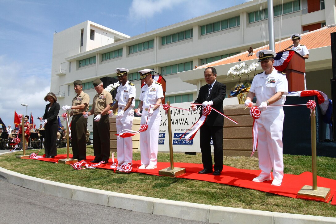 Marines, sailors and distinguished guests cut a ribbon signifying the official opening of the U.S. Naval Hospital Okinawa on Camp Foster April 30. The hospital represents Navy medicine’s enduring commitment to providing the highest level of readiness and care to military personnel and families in the Asia-Pacific region. Photo by Cpl. Brianna Turner
