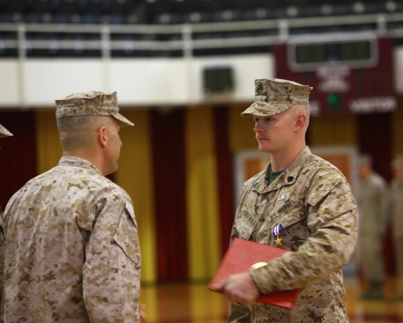 Maj. Gen. Michael G. Dana, the assistant deputy commandant for logistics at Headquarters Marine Corps, awards Staff Sgt. Daniel W. Ridgeway, an explosive ordnance disposal team leader with 2nd Explosive Ordnance Disposal Company, 8th Engineer Support Battalion, 2nd Marine Logistics Group, the Silver Star Medal during a ceremony aboard Camp Lejeune, N.C., April 30, 2013. Ridgeway was awarded for his actions in Afghanistan in support of Operation Enduring Freedom in 2011. (U.S. Marine Corps photo by Lance Cpl. Shawn Valosin)