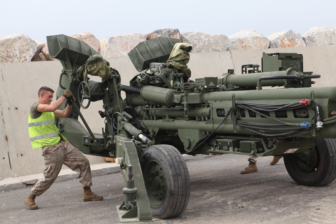 Corporal Kyle W. Daley cranks settings on a M777 Howitzer cannon here on April 11, 2013.  Daley, 22, and other servicemembers were here to prepare for the beginning of African Lion 2013.  Daley, is a cannon crewman assigned to Q Battery, 5th Battalion, 14th Marine Regiment. Exercise African Lion is a U.S. Africa Command-scheduled, U.S. Marine Corps Forces Africa- led, joint multi-lateral exercise. The joint task force consisting of U.S. Marines, soldiers, sailors and airmen were able to conduct modified joint training for Exercise African Lion 13, demonstrating their ability to adapt to unpredicted circumstances, restore mission essential tasks, build interoperability and create friendships during the remaining days of the evolution. The logistics component will continue to exercise vigilant, safe and rapid retrograde of almost 1,200 personnel and 250 short-tons of vehicles and equipment while working with Moroccan partners and contractors to sustain the force and redeploy them back to their home stations in a timely and efficient manner.