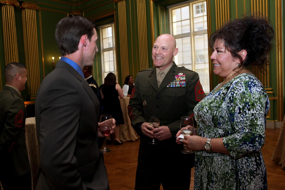 Sgt. Maj. Micheal P. Barrett, the 17th Sergeant Major of the Marine Corps, and Mrs. Susan Barrett speak to retired Staff Sgt. Johnny Jones, a wounded warrior and the special guest speaker at the Heroes of Military Medicine Awards, at the Andrew W. Mellon Auditorium in Washington, D.C., on May 1, 2013. (U.S. Marine Corps photo by Sgt. Marionne T. Mangrum)