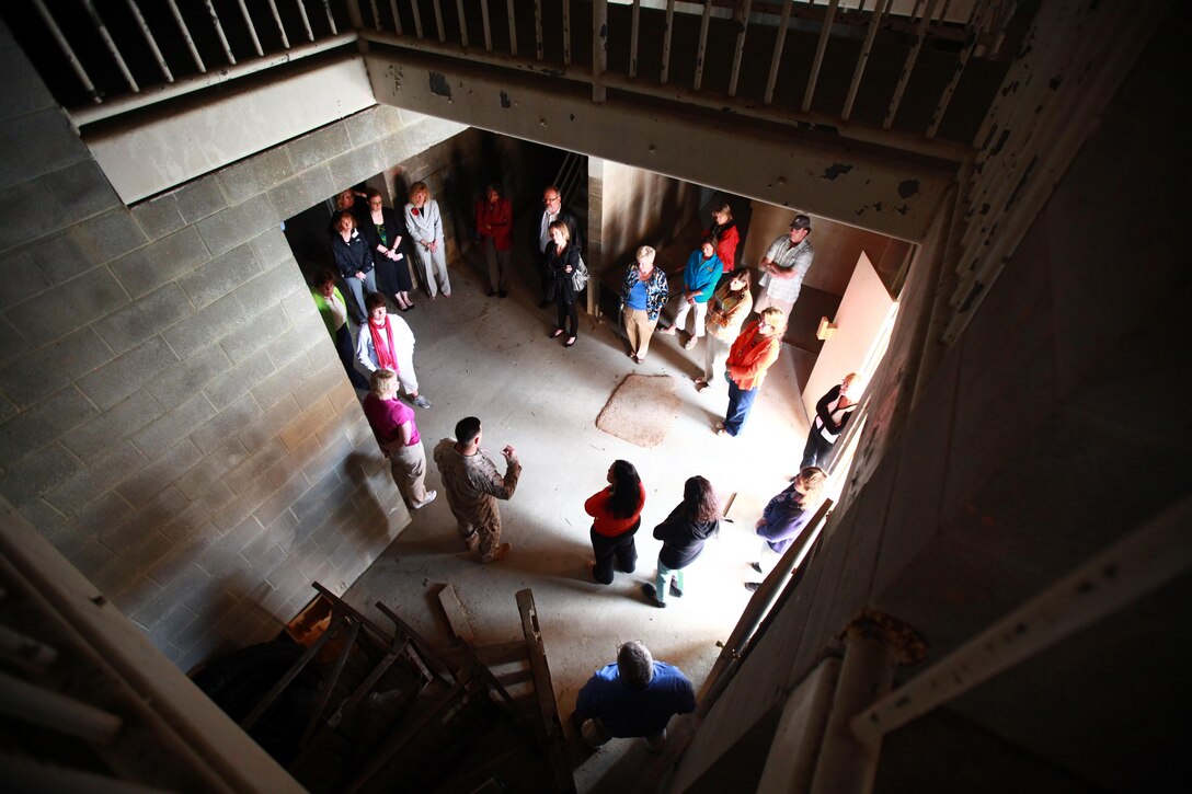 School district representatives tour a building in Military Operation Urban Terrain town, given by Staff Sgt. Donald Estes, MOUT town assistant operations chief, at MOUT town aboard Camp Lejeune during Operation Homecoming, a two-day class that allows educators the opportunity to learn how to work with military children, families and provided resources available April 25.