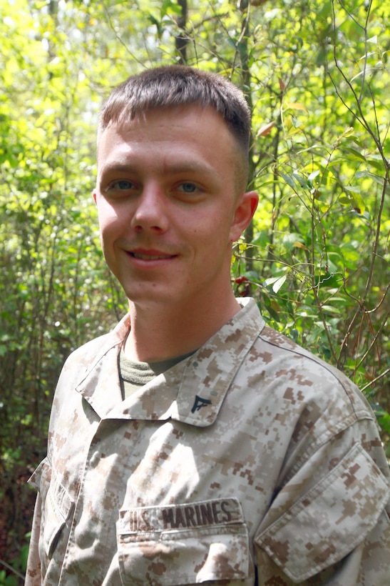 Lance Cpl. Tyler J. Smalls, an aviation ordnance systems technician with Headquarters and Headquarters Squadron, provides an escort for Environmental Affairs employees on the ordnance compound April 30. Smalls escorted environmentalists while they checked an eagle's nest for chicks.