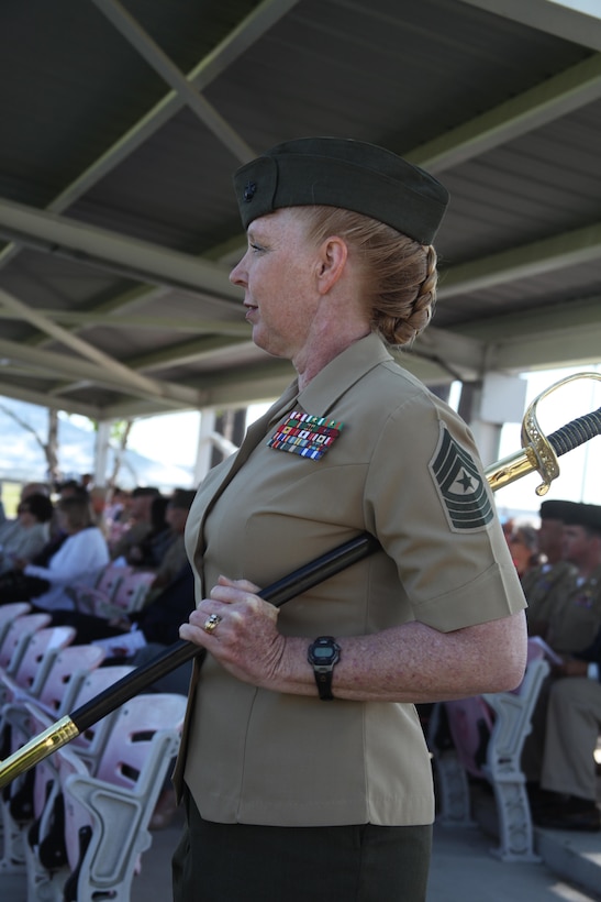 Sgt. Maj. Holly C. Prafke cradles the coveted sword of office before passing it to Sgt. Maj. David G. Eldridge during a relief and appointment ceremony April 26.