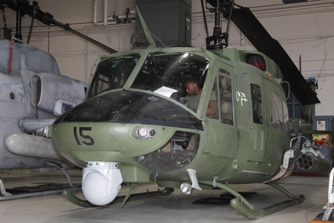 A UH-1N Huey with Marine Light Attack Helicopter Squadron 467 sits in the squadron's hangar Tuesday. As the Corps modernizes to support future missions, older sircraft like the Huey are being phased out. HMLA-467 inducted three of these Hueys into the 309th Aerospace and Maintenance Regeneration Group at Davis Monthan Air Force Base as the "Sabers" transition to UH-1Y Venoms. HMLA-467 is the last squadron in the Corps to make the transition to Venoms. 