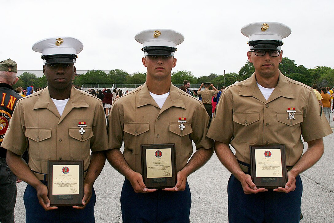 From left to right, Pfc. Billy Travis, Jr., honor graduate of platoon 2036 from Champaign, La., Pfc. Private First Class Scott Taylor, Jr., honor graduate of platoon 2032 from Deltona, Fla.,  and Pfc. Brandon Layman, honor graduate of platoon 2034 from St. Gabriel, La., all stand together after graduation aboard Parris Island, S.C., May 3, 2013. All will be able to enjoy some much deserved leave as they prepare for Marine Combat Training in Camp Geiger, N.C. (U.S. Marine Corps photo by Lance Cpl. John-Paul Imbody)