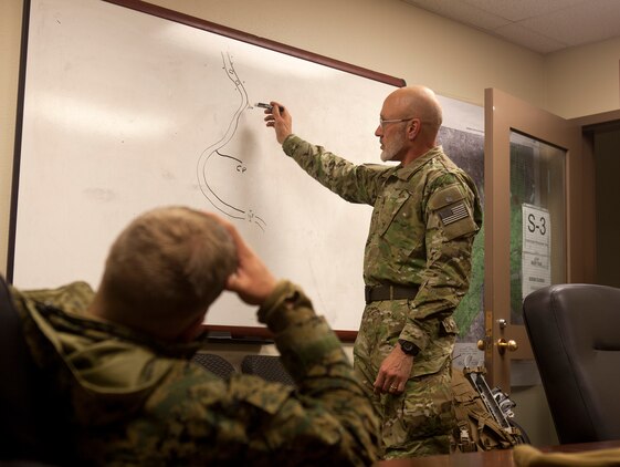MOUNTAIN WARFARE TRAINING CENTER, BRIDGEPORT, Calif. - Retired United States Navy SEAL, Capt. David Pittelkow, conducts a debrief with Mountain Warfare Training Center Marines after conducting a low-profile raid on a high-value target in a joint operation with special forces and Marines from 2nd Battalion, 3rd Marine Regiment at MWTC in Bridgeport, Calif., April 17. (Official U.S. Marine Corps photo by Lance Cpl. Suzanna Lapi)