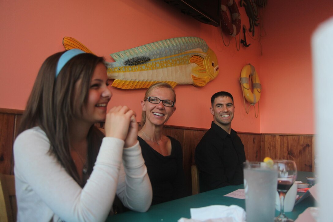 Staff Sgt. Isaiah D. Ybarra, right, his wife, Noelle, center, and their daughter, Gabrielle, 15, listen to the members of the Havelock Military Affairs Committee speak about the reasons they were being named the Havelock MAC Military Family of the Quarter at Crabby Patties April 23. Gabrielle is the Havelock High School freshman class secratary and is running for vice-president for her class for next year.