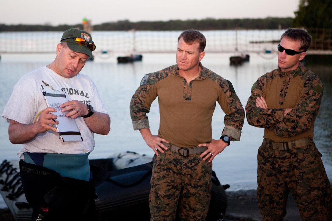 A National Park Service diver briefs a team of Marines from Force Reconnaissance Company, 3rd Marine Expeditionary Force, stationed in Okinawa, Japan, and currently attached to the 31st Marine Expeditionary Unit, here April 27 before they dive the USS Arizona. The Marines are currently on Oahu conducting sustainment training such as diving, jumps, marksmanship training and visit, board, search and seizure training.