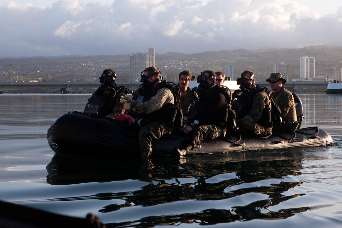 A team of Marines from Force Reconnaissance Company, 3rd Marine Expeditionary Force, stationed in Okinawa, Japan, and currently attached to the 31st Marine Expeditionary Unit, make their way toward the USS Arizona Memorial here April 27 before they dive the site. The Marines are currently on Oahu conducting sustainment training such as diving, jumps, marksmanship training and visit, board, search and seizure training. 