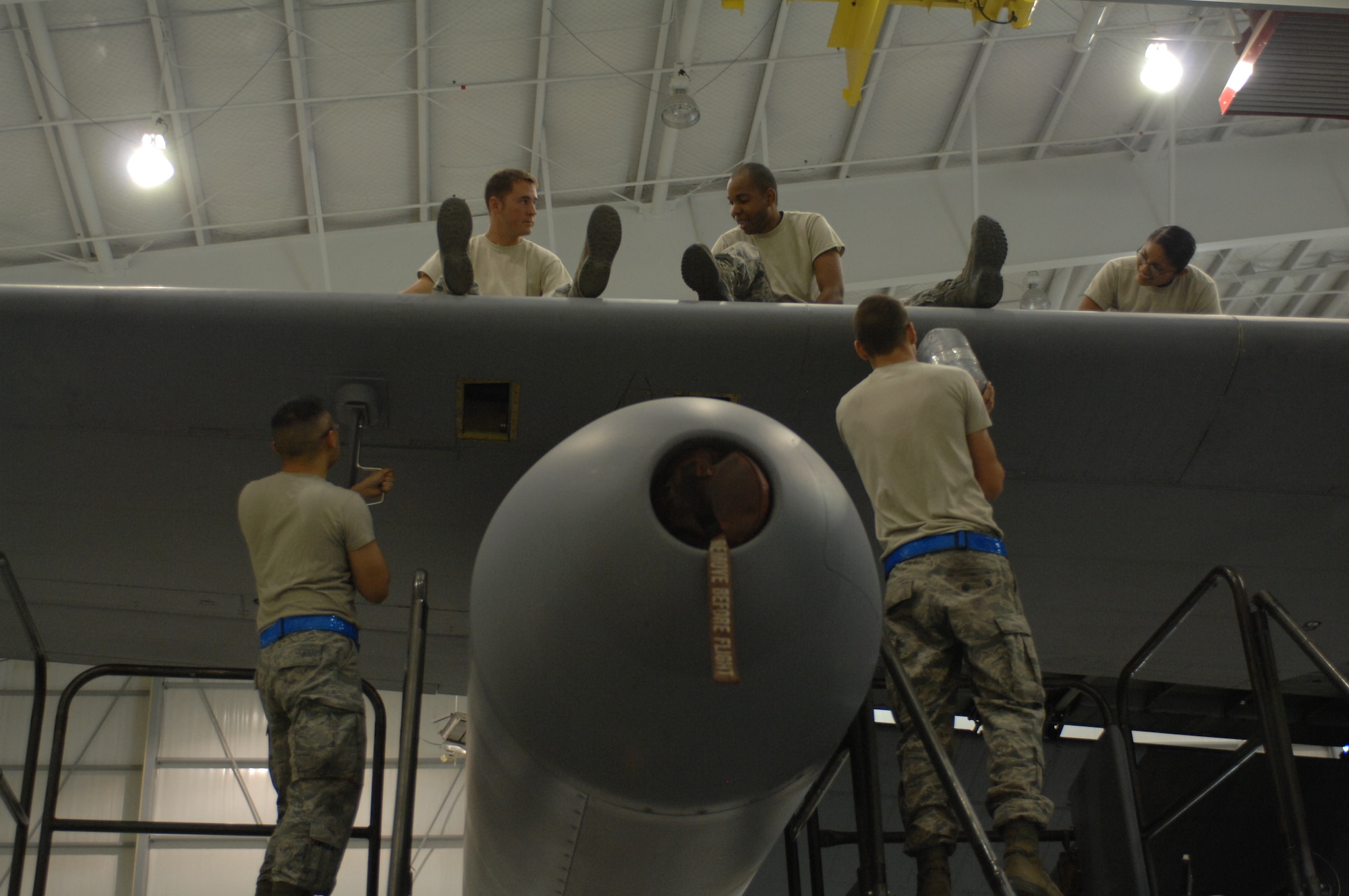 Airmen from the 755th Aircraft Maintenance Squadron re-attach the leading line on a wing of an EC-130H Compass Call aircraft at Davis-Monthan Air Force Base, Ariz. May 1, 2013. This EC-130H is one of 14 aircraft in the Air Force with the ability to find radio signals and has computer operators onboard with the knowledge to block these signals.(U.S. Air Force photo by Airman 1st Class Betty R. Chevalier/released)