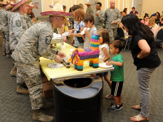 Master Sgt. Robert Azbill 489th Reconnaissance Squadron acting first sergeant serves attendees of a Hearts Apart dinner at the Community Center on Beale Air Force Base Calif., May, 2 2013. The Hearts Apart program offers spouses and children of deployed military members a chance to connect with other families experiencing similar situations. (U.S. Air Force photo by Airman 1st Class Bobby Cummings/Released)