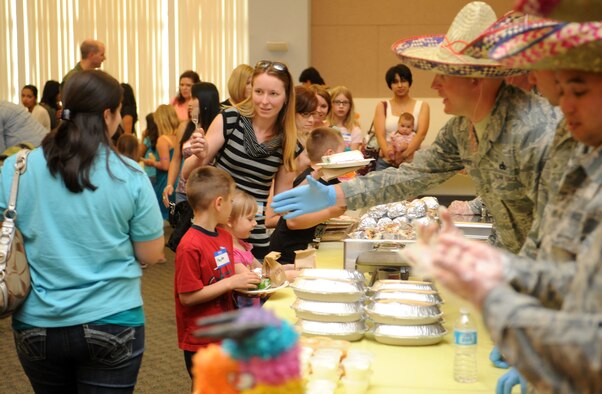 First sergeants offer a helping hand during a Hearts Apart dinner at the Community Center on Beale Air Force Base Calif., May 2, 2013. The Hearts Apart program offers spouses and children of deployed military members a chance to connect with other families experiencing similar situations. (U.S. Air Force photo by Airman 1st Class Bobby Cummings/Released)