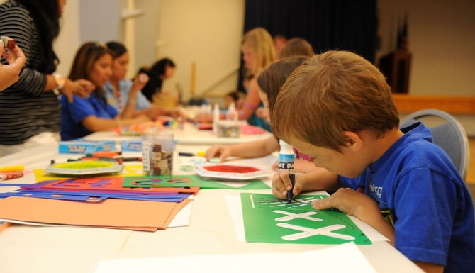 Children get creative at the arts and crafts station during a Hearts Apart dinner at the Community Center on Beale Air Force Base, Calif., May 2, 2013.The Hearts Apart program offers spouses and children of deployed military members a chance to connect with other families experiencing similar situations. (U.S. Air Force photo by Airman 1st Class Bobby Cummings/Released)