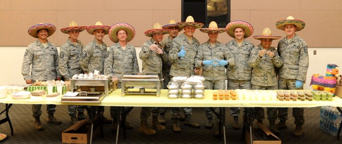 Many of Beale's first sergeants served a Cinco de Mayo-themed dinner during a Hearts Apart dinner at the Community Center on Beale Air Force Base, Calif., May 2, 2013. The Hearts Apart program offers spouses and children of deployed military members a chance to connect with other families experiencing similar situations. (U.S. Air Force photo by Airman 1st Class Bobby Cummings/Released)