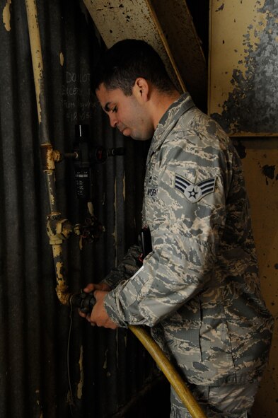 Senior Airman Michael Mazolla, 2nd Maintenance Squadron Accessories Flight Fuels Maintenance, attaches a hose to an air source used to assist in the draining of the fuel systems of a B-52H Stratofortress on Barksdale Air Force Base, La., May 3, 2013. Airmen in the fuels section have the responsibility of diagnosing and repairing the various fuel systems and fuel tanks on the B-52 to ensure the aircraft completes its mission of delivering precision munitions on the battlefield. (U.S. Air Force photo/Airman 1st Class Andrew Moua)