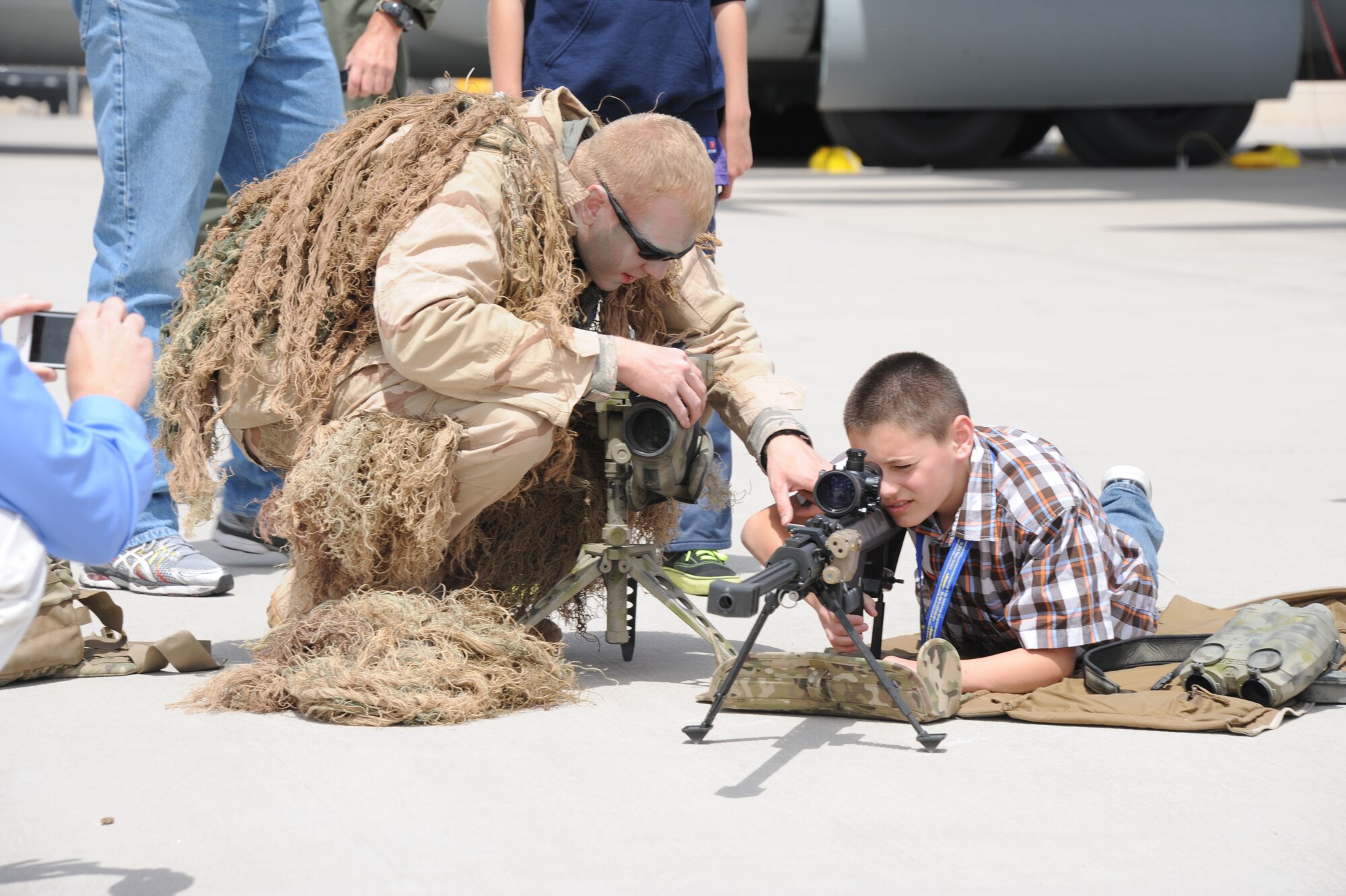 Senior Airman Brandon Davis, 377th Weapons System Security
Squadron, displays the unit’s sniper rifle. As part of “Take Our Daughters and Sons to Work Day,” employees were invited to bring their children to the base to learn more about Kirtland missions. (Photo by Todd Berenger)
