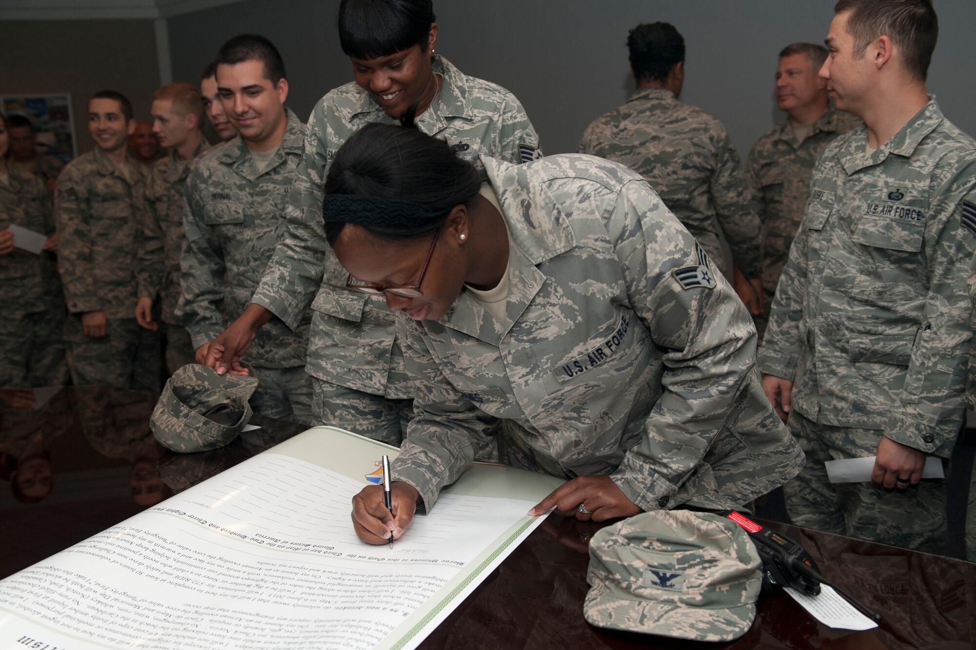 Members of Team Holloman sign an oath at Holloman Air force Base, N.M., May 3. Members pledged to either complete 30 hours of volunteer service or remain alcohol-free for 30 days from May 5 to June 6. This Alcohol Abstinence and Volunteerism Challenge hopes to increase community involvement and decrease the number of drunken driving incidents in the wing. (U.S. Air Force photo by Airman 1st Class Leah Murray/Released)