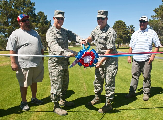 Col. Darren Bishop, 99th Mission Support Group commander (right), and Lt. Col. James Rumbley, 99th Force Support Squadron commander (left), cut a ribbon at the grand opening of the Par 3 course at the Sunrise Vista Golf Course May 2, 2013, at Nellis Air Force Base, Nev. Reconstructing Par 3 was a four month project that consisted of moving dirt and landscaping across the nine-hole course. (U.S. Air Force photo/Senior Airman Brett Clashman)