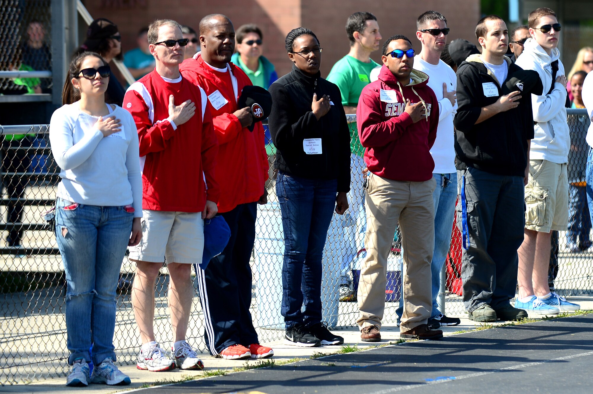 Volunteers prepare for the opening ceremony at the Chesapeake Public Schools Special Games at Oscar Smith High School, Va., April 26, 2013.  More than 1,800 children participated in the event, and more than 100 Airmen volunteered to assist with the games. (U.S. Air Force photo by Senior Airman Kayla Newman/Released)