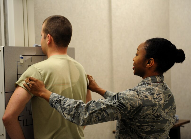 Senior Airman Natisha Haynie, 2nd Medical Support Squadron diagnostic imaging technologist, sets up an Airman for an X-ray at the radiology lab on Barksdale Air Force Base, La., May 3, 2013. The X-ray machine emits X-radiation to capture an image of the internal structures of the human body to provide doctors a way to see inside the body to locate possible injuries. (U.S. Air Force photo/Airman 1st Class Benjamin Gonsier)
