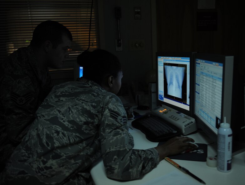 Staff Sgt. Sean McCarty and Senior Airman Natisha Haynie, 2nd Medical Support Squadron diagnostic imaging technologists, view an image from a computed tomography scan at the radiology lab on Barksdale Air Force Base, La., May 3, 2013. The images provide an in-depth look into a patient's body and provide detailed images for doctor's to properly diagnose what may be wrong. (U.S. Air Force photo/Airman 1st Class Benjamin Gonsier)