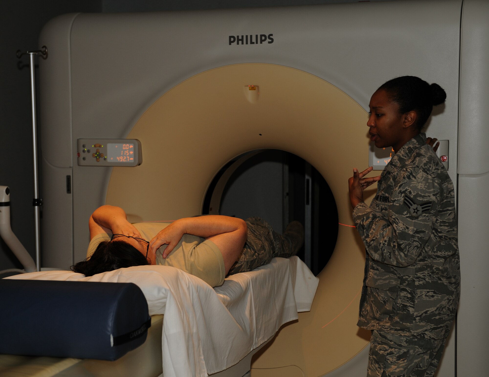 Senior Airman Natisha Haynie, 2nd Medical Support Squadron diagnostic imaging technologist, prepares a patient for a computed tomography scan at the radiology lab on Barksdale Air Force Base, La., May 3, 2013. CT scanners provide an in-depth look into a patient's body and provide detailed images for doctor's to properly diagnose what may be wrong. (U.S. Air Force photo/Airman 1st Class Benjamin Gonsier)
