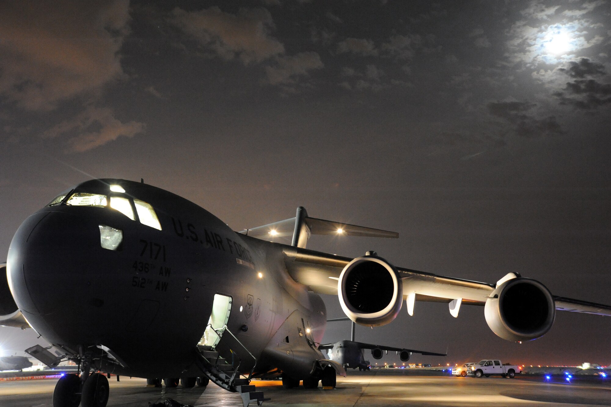 An Air Mobility Command C-17 Globemaster III awaits final loading under moonlight April 30, 2013, at an undisclosed base in Southwest Asia. The C-17 is the newest, most flexible cargo aircraft to enter the airlift force and is capable of rapid strategic delivery of troops and all types of cargo to main operating bases or directly to forward bases in the deployment area. (U.S. Air Force photo/Senior Master Sgt. George Thompson)