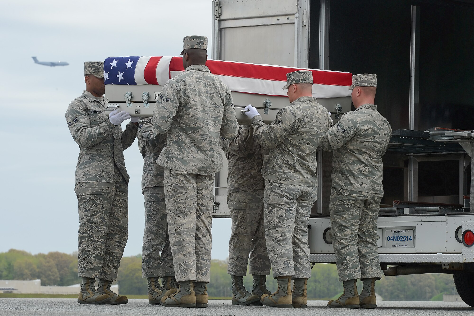 A U.S. Air Force carry team transfers the remains of Capt. Reid K. Nishizuka, of Kailua, Hawaii, during a dignified transfer, April 30, 2013, Dover Air Force Base, Del. Nishizuka was assigned to the 427th Reconnaissance Squadron, Beale AFB, Calif. (U.S. Air Force photo/Greg L. Davis)