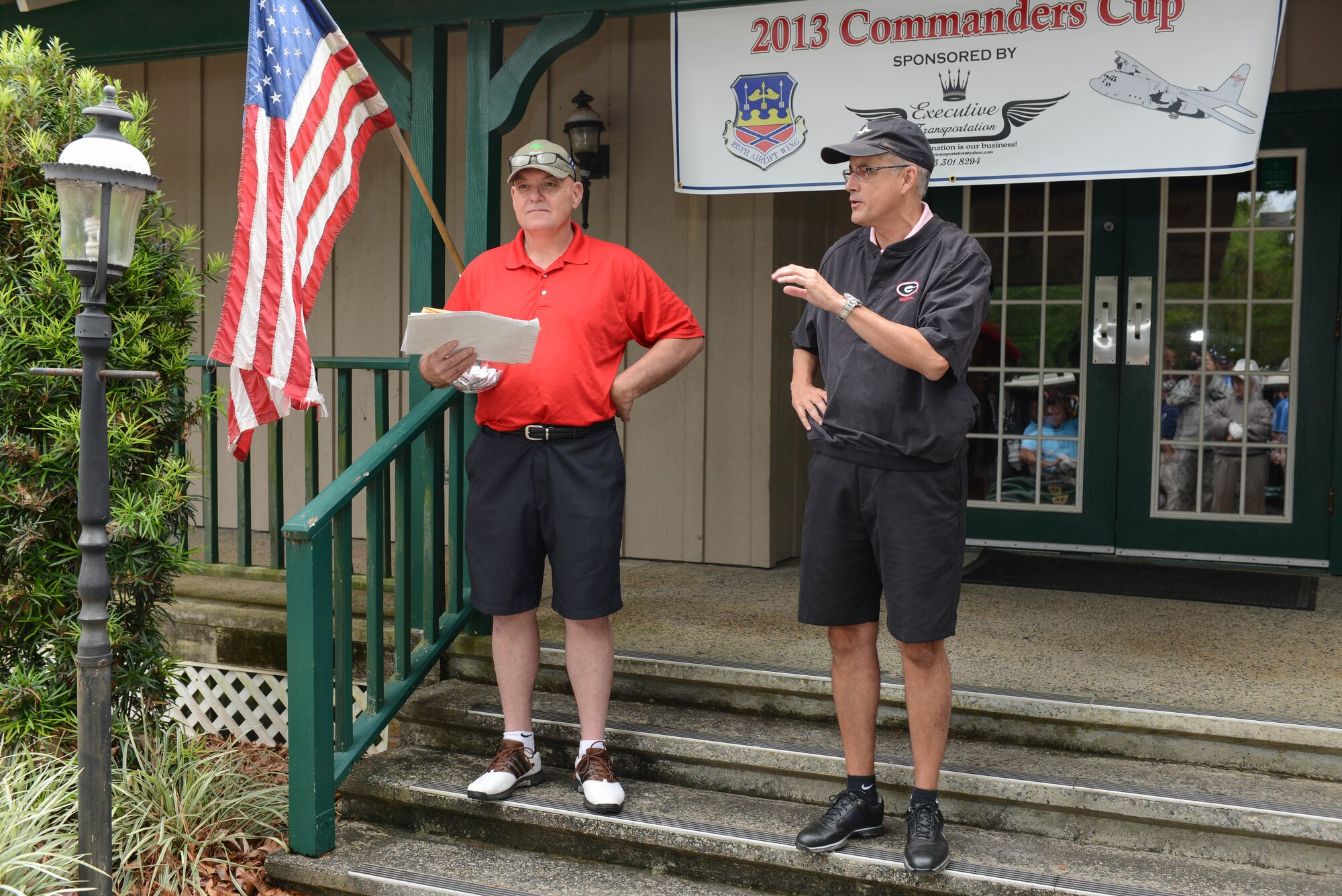 Col. Rainer 'Speedy' Gomez, Air Commander for the 165th Airlift Wing, Georgia Air National Guard recognizes distiguished guests at the start of the 2013 Commander's Cup golf tournament May 3, 2013 at Lost Plantation Golf Course in Rincon, Ga. Chief Master Sgt. Roy Patterson (left) holds door prize tickets. (U.S. Air National Guard photo by Tech. Sgt. Charles Delano/Released)
