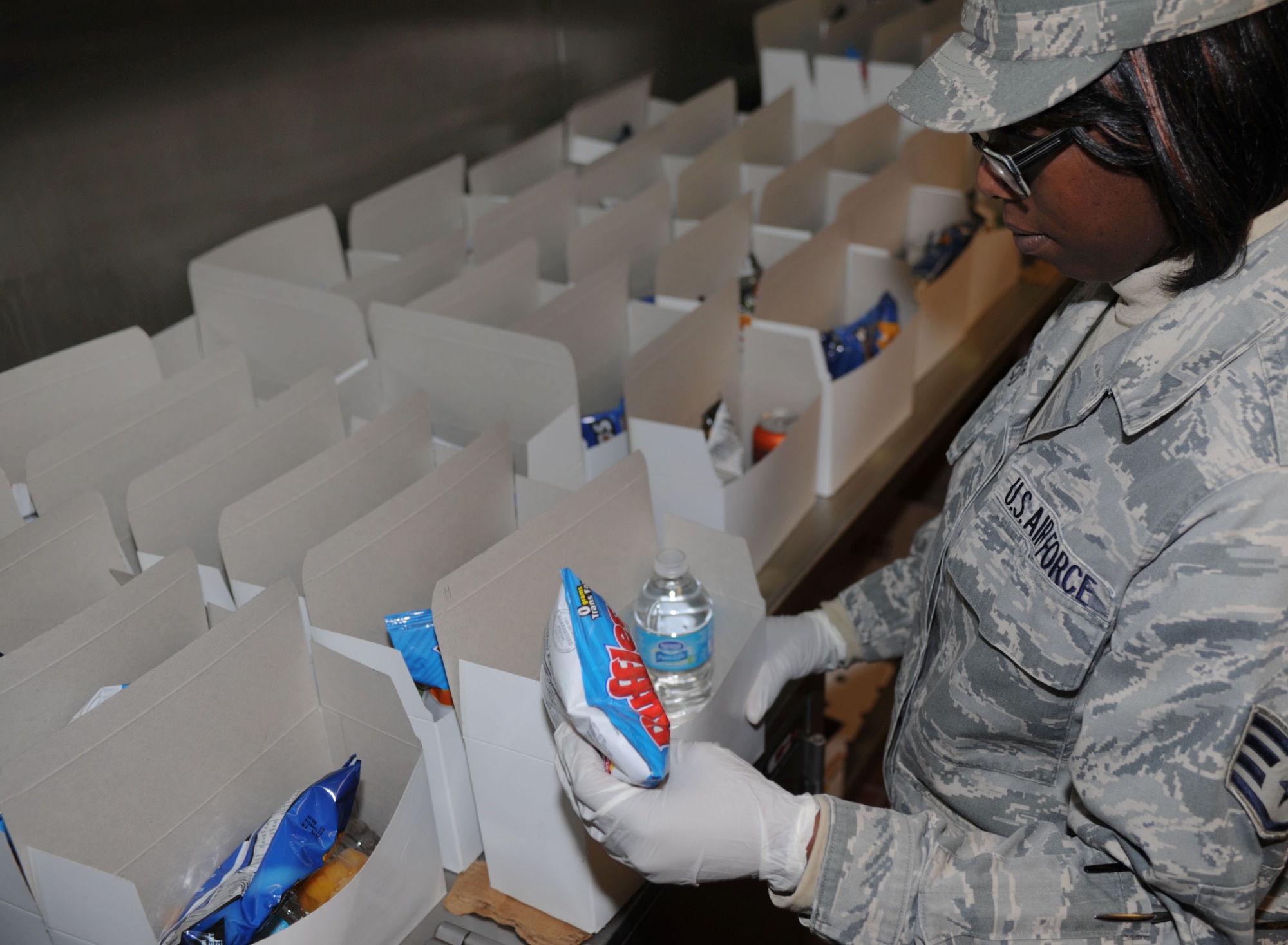 U.S. Air Force Staff Sgt. Shimika Burgess, 27th Special Operations Force Support Squadron, creates meals in the Pecos Trail Dining Facility flight kitchen at Cannon Air Force Base, N.M., May 2, 2013. Flight kitchen is open from 8:30p.m. to 5:30a.m. and serves a variety of foods to meet the different dietary needs of military members. (U.S. Air Force photo/Airman 1st Class Ericka Engblom)