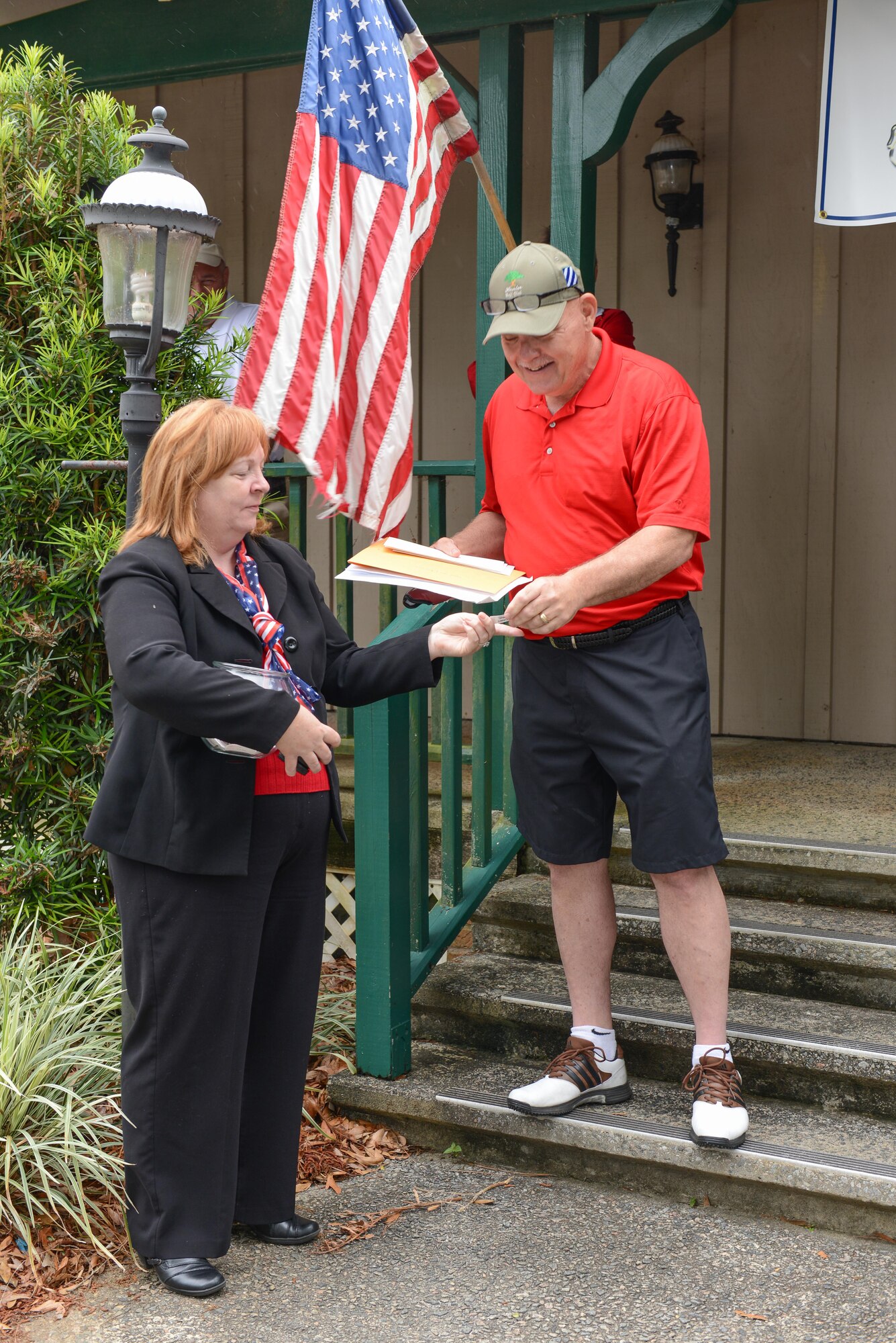 Sue Iacovone, sponsor of the 165th Airlift Wing's 2013 Commander's Cup golf tournament picks door prize tickets as Chief Master Sgt. Roy Patterson announces the winning names, May 3, 2013 at Lost Plantation Golf Course in Rincon, Ga. Proceeds for the tournament support unit morale events throughout the year. (U.S. Air National Guard photo by Tech. Sgt. Charles Delano/Released)