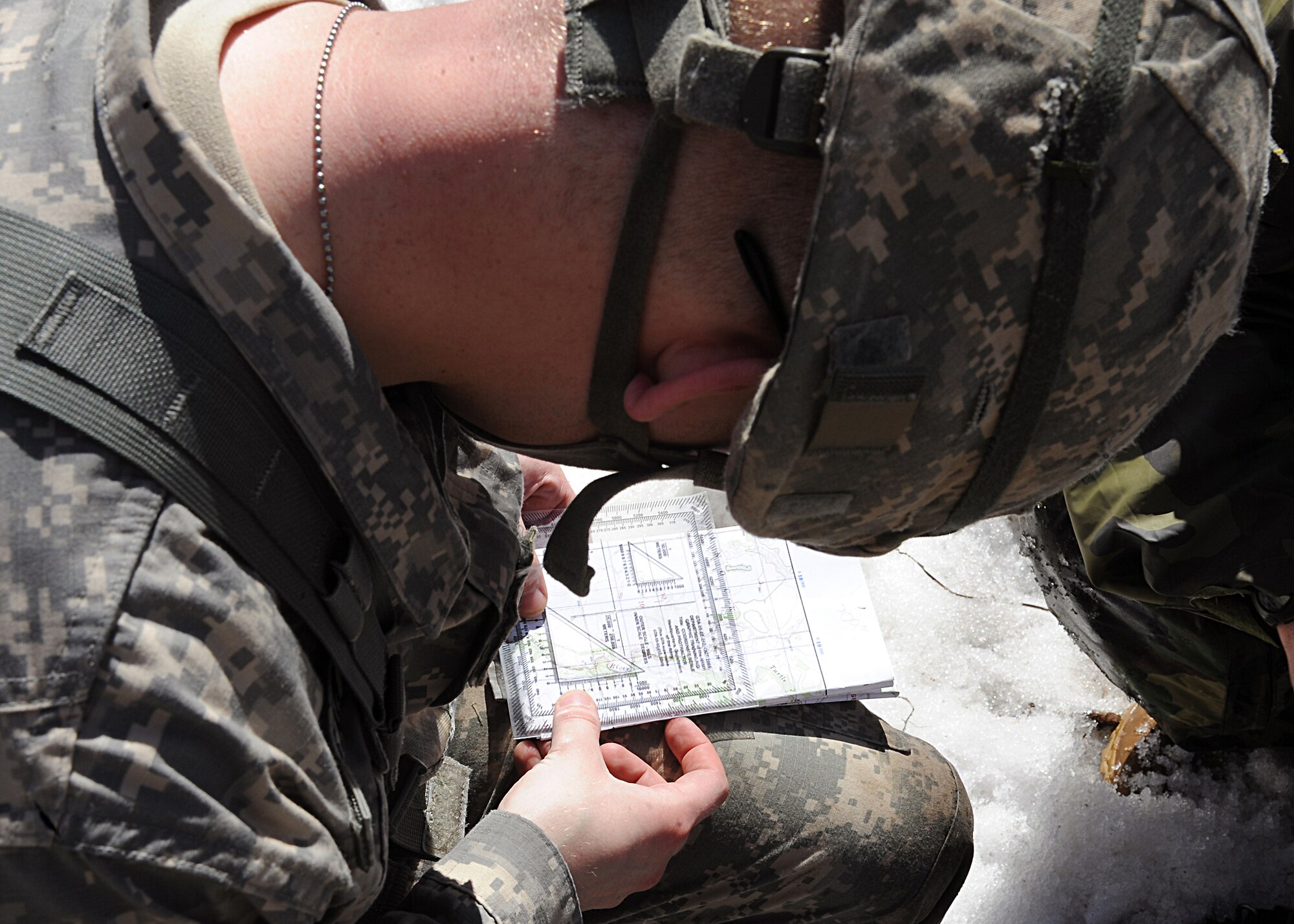 University of North Dakota Army Reserve Officer Training Corps cadets coordinate points on a map to determine the unit’s current location, April 26, 2013, while training on Grand Forks Air Force Base, N.D. The cadets who participated in this training were all students of the University of North Dakota’s ROTC program (U.S. Air Force photo/Airman 1st Class Xavier Navarro)