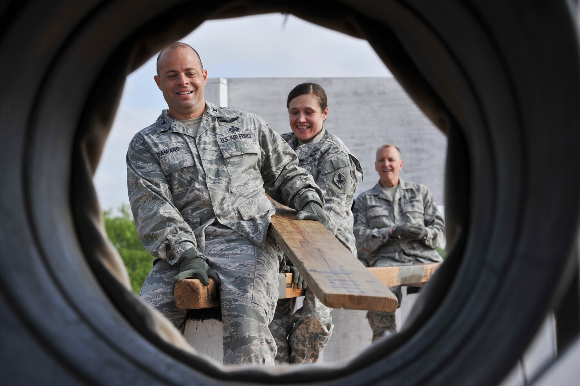 GOODFELLOW AIR FORCE BASE, Texas--  Col. Mark Damiano, 17th Training Wing Commander, works with Army Lt. Col. Devon Blake, 433th Military Intelligence Battalion Commander, to place down a plank while participating in the Leadership Reaction Course April, 30. The obstacles in the course help to promote the use of team work and communication. (U.S. Air Force photo/ Airman 1st Class Michael Smith)