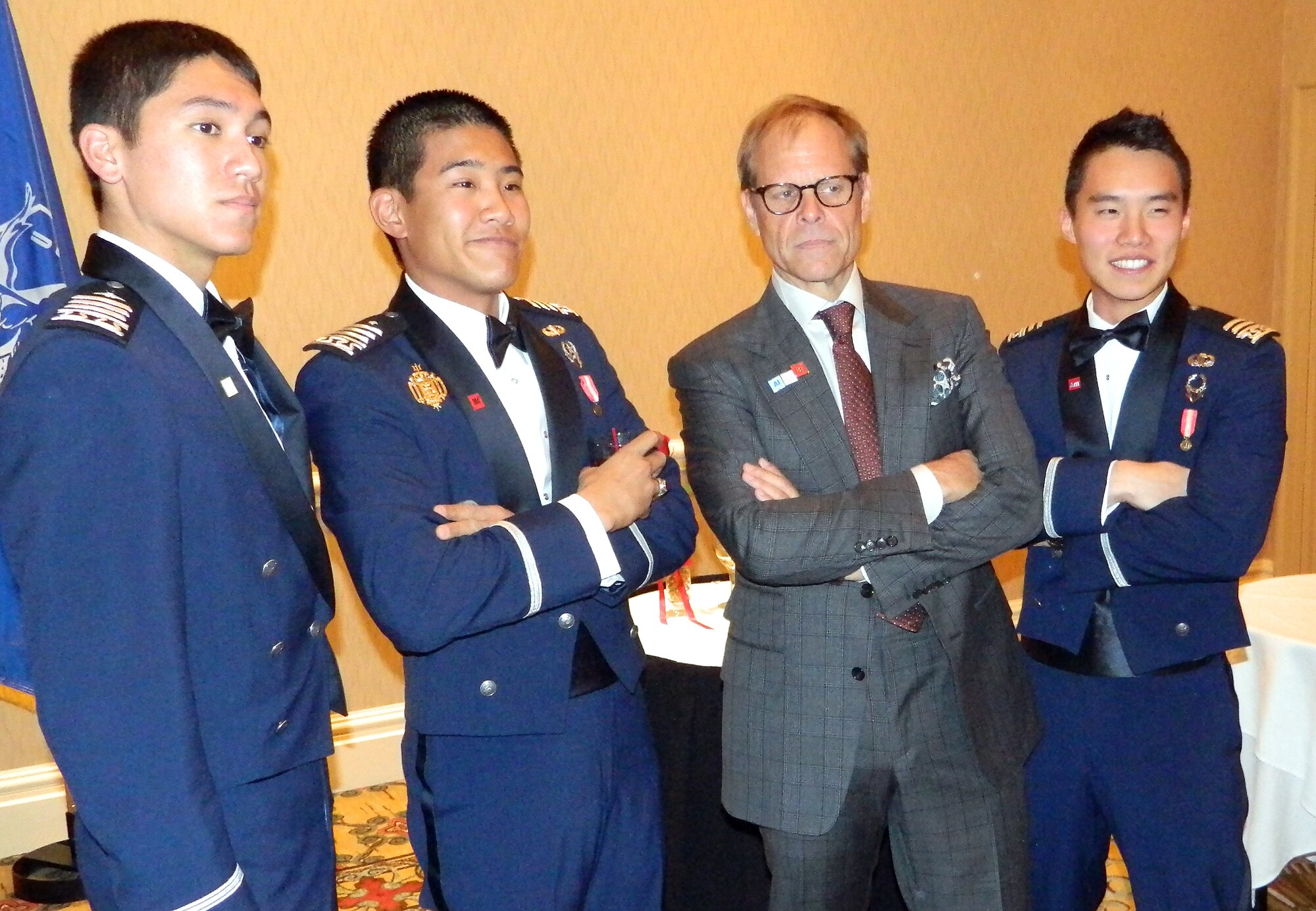 Celebrity cook Alton Brown poses for a photo with cadets majoring in chemistry during the Chemistry Department Dining-Out at the Antlers Hilton in Colorado Springs April 26, 2013. Brown, the creator and host of Food Network's "Good Eats," talked about common kitchen myths and the relationship between cooking and chemistry. (U.S. Air Force photo/Amber Baillie)