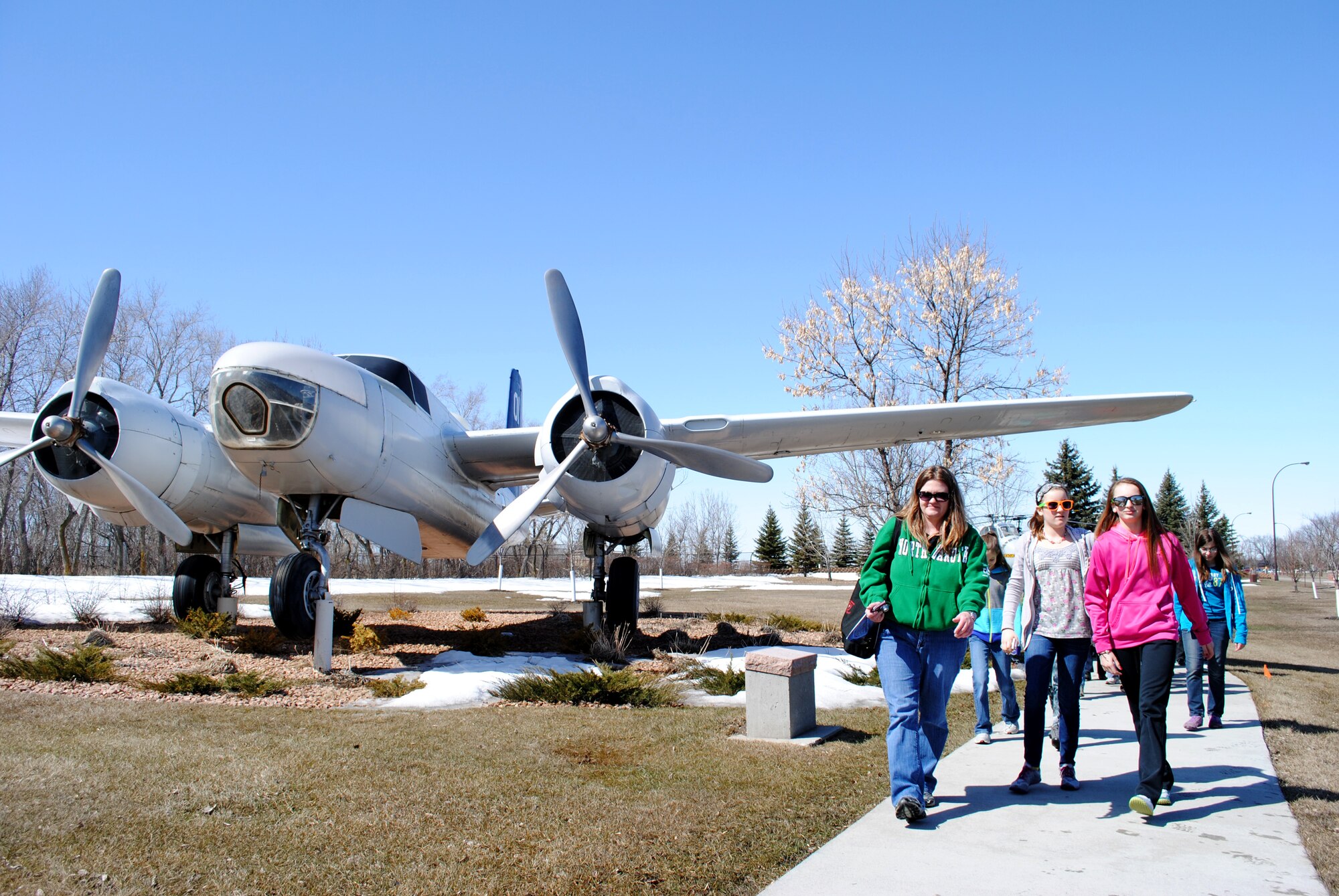 Chaperones and students from St. Joseph’s Catholic School in Devils Lake, N.D., take a tour of the military vehicles and aircraft that make up the outdoor museum located outside the main gate of Grand Forks Air Force Base, N.D. on April 26, 2013. The outdoor museum was the last stop of the group’s tour of the base. Grand Forks AFB offers base tours each Friday from March through October. (U.S. Air Force photo/Staff Sgt. Luis Loza Gutierrez)