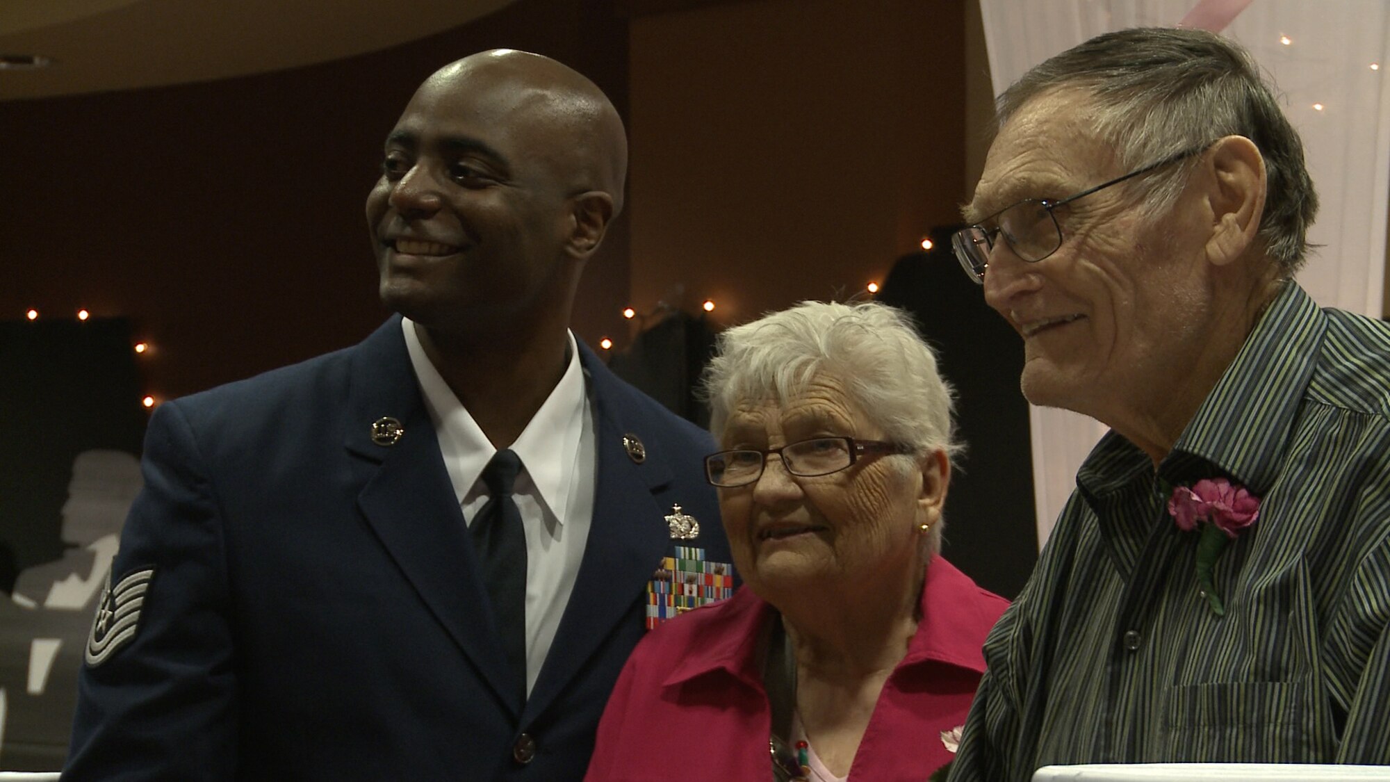 Tech. Sgt. Reginald Ester, 319th Logistics Readiness Squadron, accompanies Lorraine and Stanley Bohac to the Annual Senior Prom Grand March at the Woodside Village Valley Memorial Home, April 26, 2013, in Grand Forks, N.D. This is the ninth year Airmen from Grand Forks Air Force Base, N.D., have escorted senior citizens during the grand march portion of their senior prom. (U.S. Air Force photo/Airman 1st Class Josh Weaver)