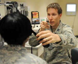 U.S. Air Force Capt. Sean Berensen, 633rd Medical Group optometrist, conducts an eye exam on Chief Master Sgt. Elaine Cole, Air Combat Command commander support staff superintendent, during her annual eye exam at Langley Air Force Base, Va., April 18, 2013. In addition to routine eye exams, the clinic offers single, bi-focal, tri-focal, spectacle and contact lens prescriptions to all active-duty personnel. (U.S. Air Force photo by Staff Sgt. Antoinette Gibson/Released)