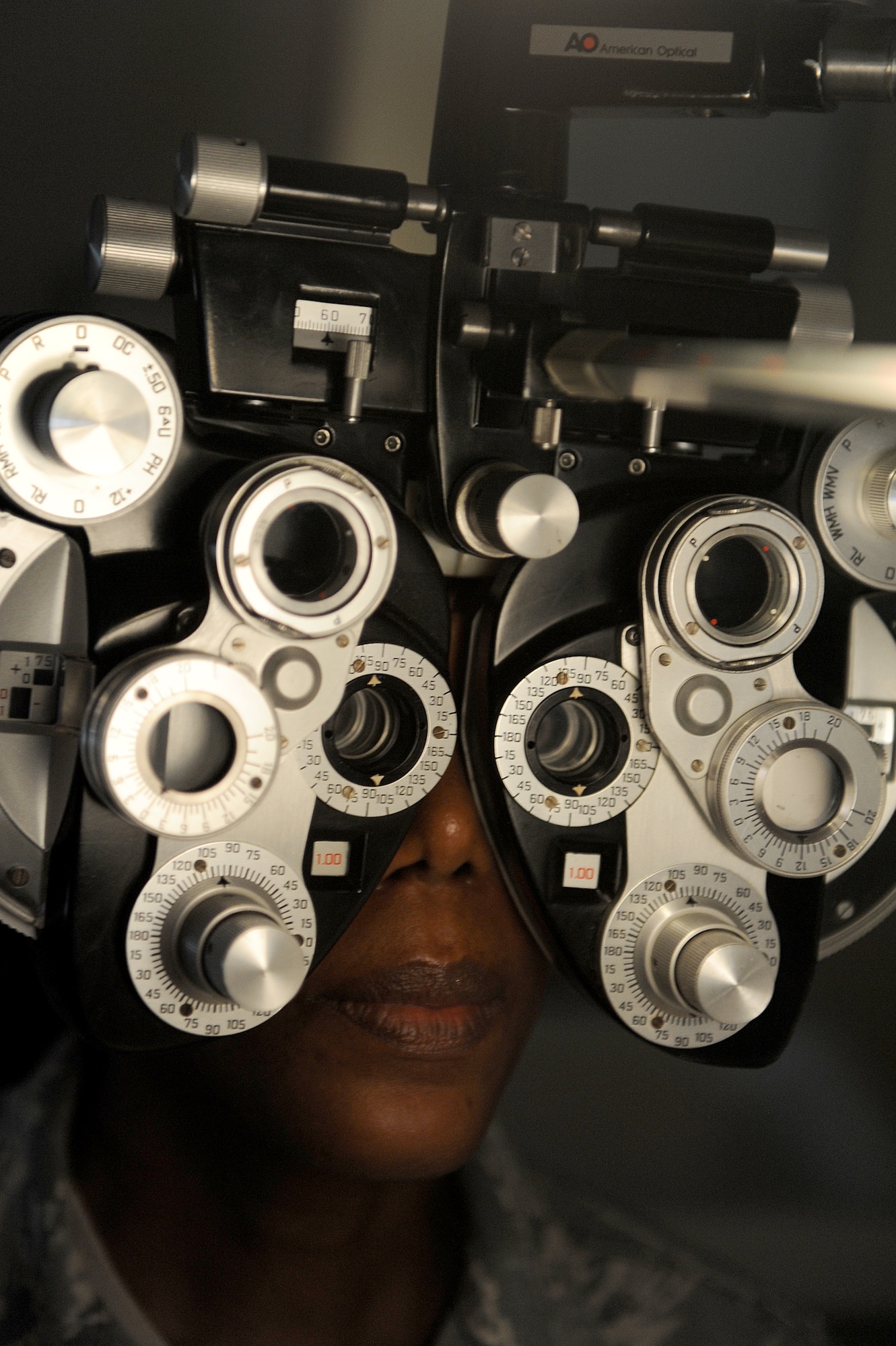 Chief Master Sgt. Elaine Cole, Air Combat Command commander support staff superintendent, looks through a phoropter at Langley Air Force Base, Va., April 18, 2013. A phoropter is an instrument used during an eye examination to measure refractive error and determine eyeglass prescriptions. (U.S. Air Force photo by Staff Sgt. Antoinette Gibson/Released)