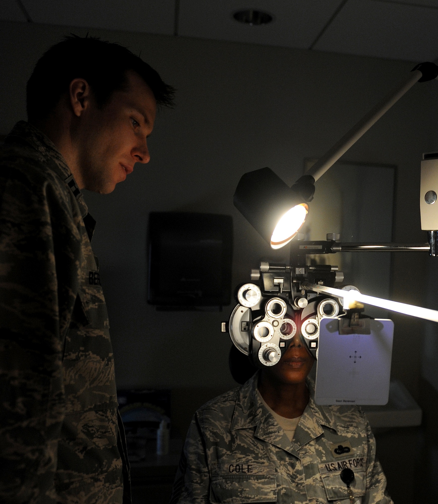 U.S. Air Force Capt. Sean Berensen, 633rd Medical Group optometrist, conducts an eye-exam on Chief Master Sgt. Elaine Cole, Air Combat Command commander support staff superintendent, during her annual eye exam at Langley Air Force Base, Va., April 18, 2013. Langley clinic professionals suggest that everyone schedule an annual eye exam to ensure any possible problems are caught at an early stage. (U.S. Air Force photo by Staff Sgt. Antoinette Gibson/Released)