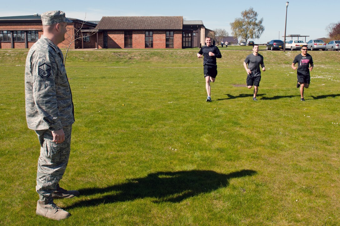 RAF ALCONBURY, United Kingdom – The winning team of Master Sgt. Brandon Mila, Tech. Sgt. Devlin Stalion and Staff Sgt. Madaleno Martinez Jr., all from the 423rd Security Forces Squadron, come in for the last question of the race. Teams went to five locations across the base answering questions and competing in challenges before they could get chips. The first team to gather five chips and bring them back to the RAF Alconbury Airman and Family Readiness building won the race. (U.S. Air Force photo by Staff Sgt. Brian Stives)
