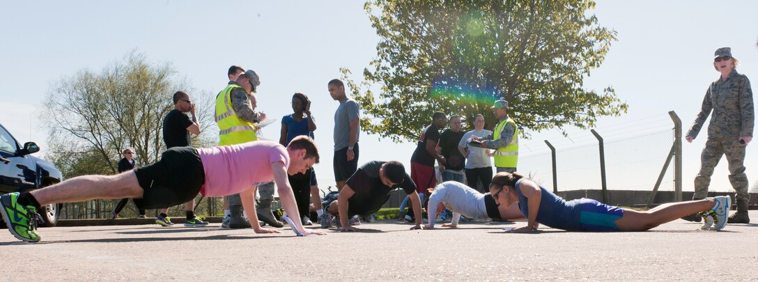 RAF ALCONBURY, United Kingdom – Members of the 501st Combat Support Wing team do pushups at the RAF Alconbury Fire Department while competing in the “Amazing Race” on RAF Alconbury May 2. Teams had three minutes to name all of the countries in the Asian Pacific area. Team members then had to do one pushup for each incorrect answer. (U.S. Air Force photo by Staff Sgt. Brian Stives)