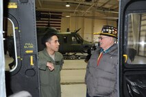 MINOT AIR FORCE BASE, N.D. – 1st Lt. Jonathan Bonilla, 54th Helicopter Squadron standards and evaluations officer, gives Richard Stark, a retired U.S. Army helicopter engine repairman, a tour of UH-1N Huey here. Stark reminisced about his time in service when he worked on the older version of the Huey aircraft during the Vietnam War. (U.S. Air Force photo/Airman 1st Class Stephanie Ashley)