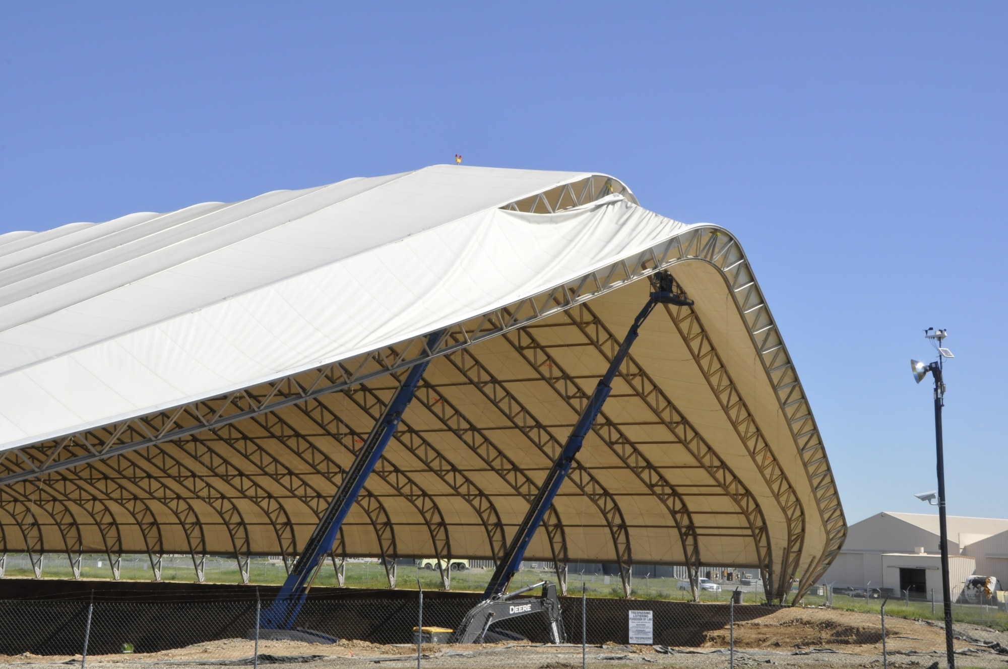 FORMER MCCLELLAN AIR FORCE BASE, Calif. – 2. Demolition begins. After 14 years as a familiar landmark at the former McClellan Air Force Base, Calif., the “big white tent” that once covered tons of contaminated soil has come down. The tent provided shelter for cleanup crews and kept 23,409 cubic yards of contaminated soil at the site from being disturbed. After the Air Force removed the soil and crews demolished the tent in April. (U.S. Air Force photo)