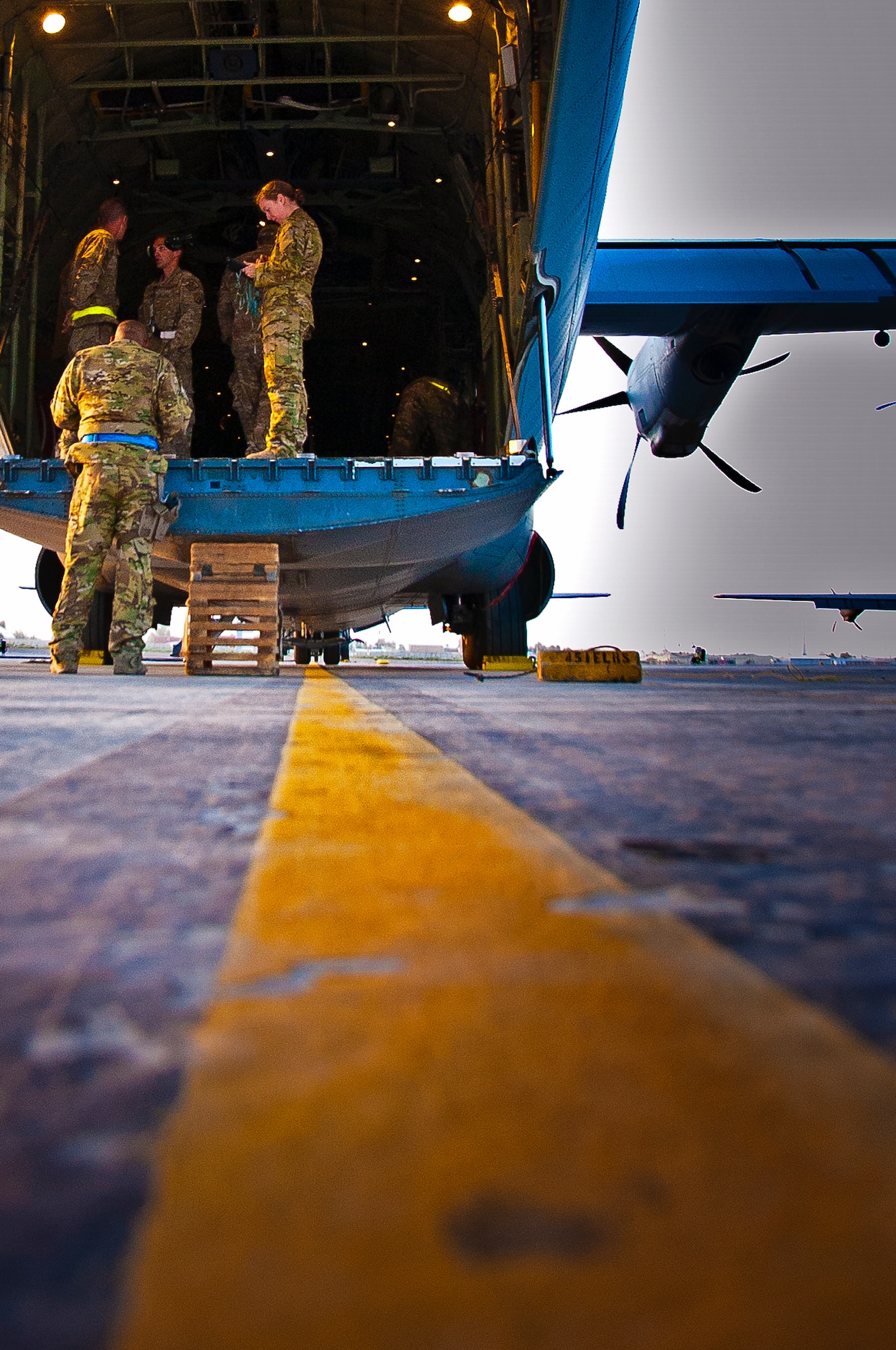 Crewmembers make final adjustments before loading cargo onto a C-130J Hercules for the first Extracted Container Delivery System in Afghanistan mission April 29. (U.S. Air Force photo by Senior Airman Scott Saldukas)