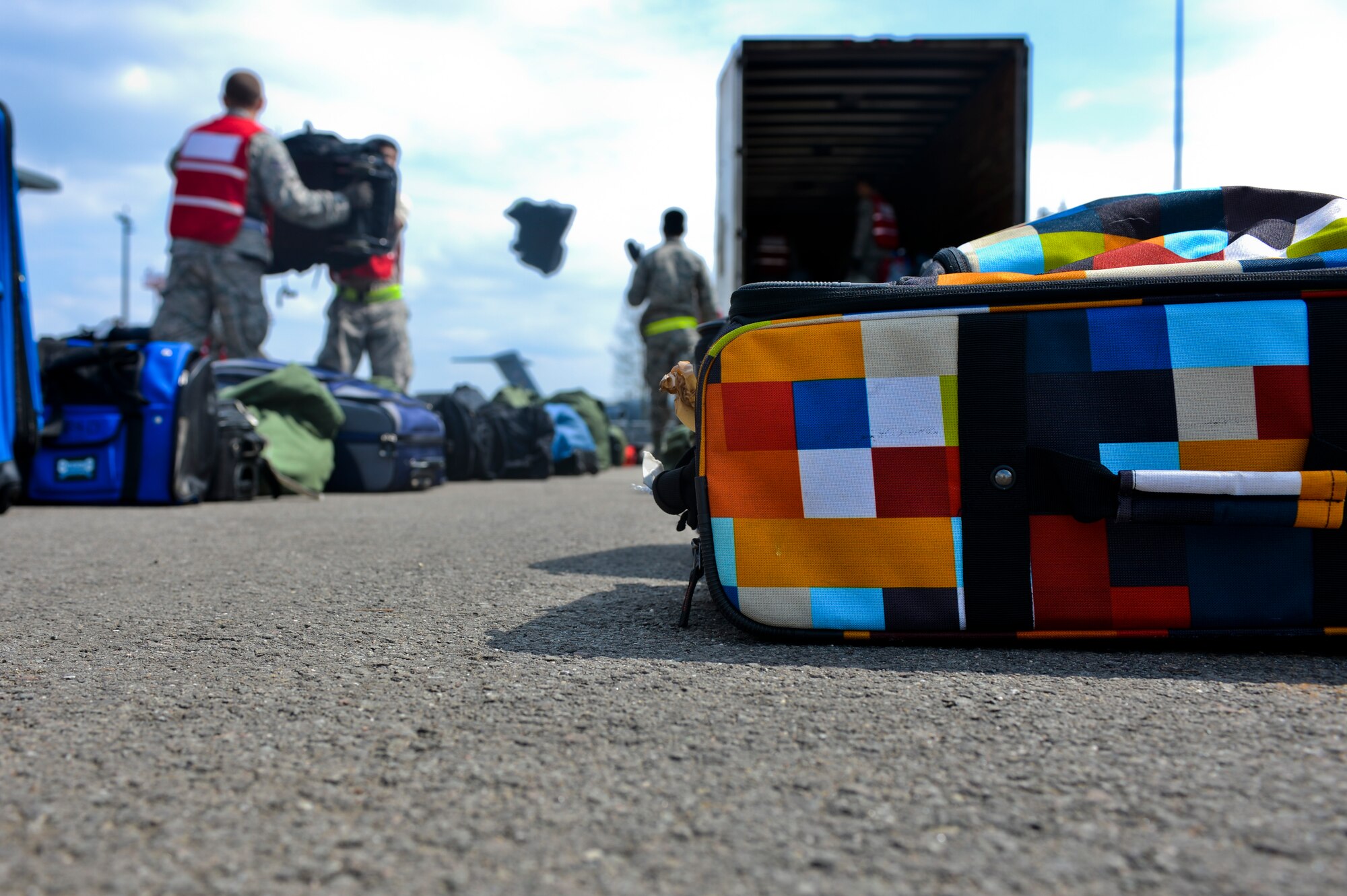 “Evacuee's” bags are unloaded and sorted during a readiness inspection on Ramstein Air Base, Germany, May 2, 2013. The purpose of this readiness inspection was to test Ramstein’s Airmen ability to safely evacuate and receive noncombatants from a hostile environment.  (U.S. Air Force photo/Airman 1st Class Jordan Castelan)